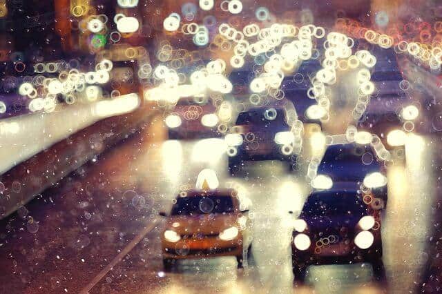 Cars lane changing in rainy traffic