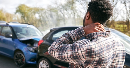 man holding neck after injury