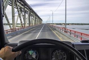 Truck driver on open bridge