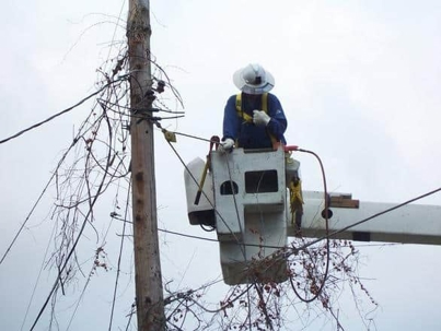 technician repairing an electrical post