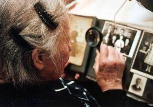Old woman checking on some old photos