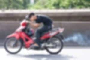 Man riding a motorcycle without a helmet